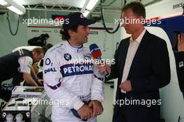 25.11.2006 Valencia, Spain, Saturday, Alessandro Zanardi (ITA), BMW Team Italy-Spain - ROAL Motorsport, WTCC, is interviewed by DST Sports TV Channel - DELL Formula BMW World Final 2006, 23th - 26th November, Circuit de la Comunitat Valenciana Ricardo Tormo - For further information please register at www.formulabmwworldfinal-images.com - This image is free for editorial use only. Please use for Copyright/Credit: c BMW AG