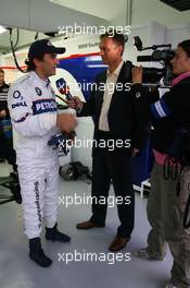 25.11.2006 Valencia, Spain, Saturday, Alessandro Zanardi (ITA), BMW Team Italy-Spain - ROAL Motorsport, WTCC, is interviewed by DST Sports TV Channel - DELL Formula BMW World Final 2006, 23th - 26th November, Circuit de la Comunitat Valenciana Ricardo Tormo - For further information please register at www.formulabmwworldfinal-images.com - This image is free for editorial use only. Please use for Copyright/Credit: c BMW AG