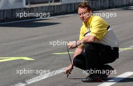 20.04.2007 Hockenheim, Germany,  Dunlop engineer checking the temperature of the concrete in the pits. - DTM 2007 at Hockenheimring (Deutsche Tourenwagen Masters)