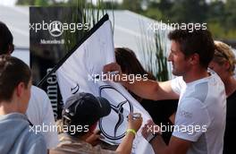 21.04.2007 Hockenheim, Germany,  Bernd Schneider (GER), Team HWA AMG Mercedes, AMG Mercedes C-Klasse is signing a Mercedes flag for a fan and giving autographs to the fans on Saturday afternoon. - DTM 2007 at Hockenheimring (Deutsche Tourenwagen Masters)