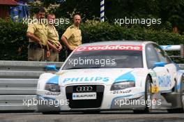 22.06.2007 Nürnberg, Germany,  Police men watching the car of Lucas Luhr (GER), Audi Sport Team Rosberg, Audi A4 DTM, passing by - DTM 2007 at Norisring