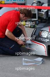22.06.2007 Nürnberg, Germany,  Audi technician changing some aerodynamical parts on the front of one of the Audi cars. - DTM 2007 at Norisring