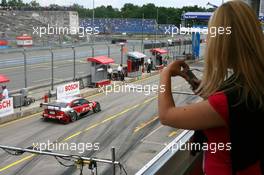 22.06.2007 Nürnberg, Germany,  A girl photographing the cars in the pitlane with her mobile phone - DTM 2007 at Norisring