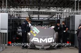 23.06.2007 Nürnberg, Germany,  While HWA mechanics work on the motor of the car of Mika Häkkinen (FIN), Team HWA AMG Mercedes, AMG Mercedes C-Klasse, other mechanics shield the activities off by the motorhood. - DTM 2007 at Norisring