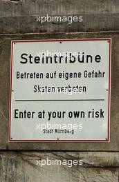 23.06.2007 Nürnberg, Germany,  Sign on the wall of the Stein Grandstand to warn people of their own risk. - DTM 2007 at Norisring