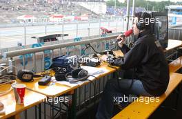 23.06.2007 Nürnberg, Germany,  On the pitroof the live radio commentator is seated. He has timing and television in front of him to keep up with the latest developments to inform the local public. - DTM 2007 at Norisring