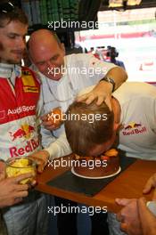 14.07.2007 Scarperia, Italy,  Mattias Ekström (SWE), Audi Sport Team Abt Sportsline, Portrait, celebrating his 29th birthday with a birthday cake. The team forces him to put his face into the cake. He gets a bit of help from Dr. Wolfgang Ullrich (GER), Audi's Head of Sport - DTM 2007 at Autodromo Internazionale del Mugello