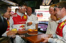 14.07.2007 Scarperia, Italy,  Mattias Ekström (SWE), Audi Sport Team Abt Sportsline, Portrait, celebrating his 29th birthday with a birthday cake. The team forces him to put his face into the cake. Het got a bit of help from Dr. Wolfgang Ullrich (GER), Audi's Head of Sport - DTM 2007 at Autodromo Internazionale del Mugello
