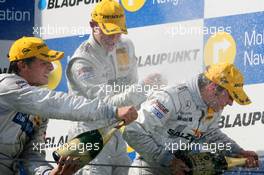 23.09.2007 Barcelona, Spain,  Podium, Jamie Green (GBR), Team HWA AMG Mercedes, Portrait (1st, right), gets a champaign shower from Bruno Spengler (CDN), Team HWA AMG Mercedes, Portrait (2nd, left) and Paul di Resta (GBR), Persson Motorsport AMG Mercedes, Portrait (3rd, center) - DTM 2007 at Circuit de Catalunya