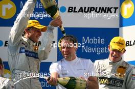 23.09.2007 Barcelona, Spain,  Podium, Gerhard Ungar (GER), Chief Designer AMG, gets a champaign shower from Bruno Spengler (CDN), Team HWA AMG Mercedes, Portrait (2nd). Background: Paul di Resta (GBR), Persson Motorsport AMG Mercedes, Portrait (3rd) - DTM 2007 at Circuit de Catalunya