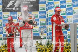 21.10.2007 Sao Paulo, Brazil,  Fernando Alonso (ESP), McLaren Mercedes and Kimi Raikkonen (FIN), Räikkönen, Scuderia Ferrari - Formula 1 World Championship, Rd 17, Brazilian Grand Prix, Sunday Podium