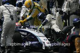 21.10.2007 Sao Paulo, Brazil,  A Willaims mechanic is knocked to to floor by Kazuki Nakajima (JPN) Williams F1 Team during a pit stop - Formula 1 World Championship, Rd 17, Brazilian Grand Prix, Sunday Race