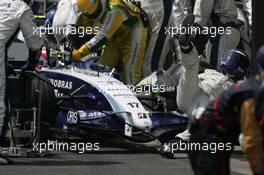 21.10.2007 Sao Paulo, Brazil,  A Willaims mechanic is knocked to to floor by Kazuki Nakajima (JPN) Williams F1 Team during a pit stop - Formula 1 World Championship, Rd 17, Brazilian Grand Prix, Sunday Race