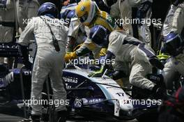 21.10.2007 Sao Paulo, Brazil,  A Willaims mechanic is knocked to to floor by Kazuki Nakajima (JPN) Williams F1 Team during a pit stop - Formula 1 World Championship, Rd 17, Brazilian Grand Prix, Sunday Race