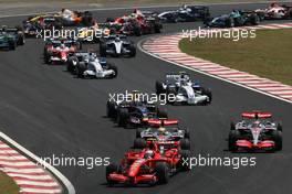 21.10.2007 Sao Paulo, Brazil,  Start, Felipe Massa (BRA), Scuderia Ferrari, F2007, Kimi Raikkonen (FIN), Räikkönen, Scuderia Ferrari, F2007 and Lewis Hamilton (GBR), McLaren Mercedes, MP4-22, Fernando Alonso (ESP), McLaren Mercedes, MP4-22  - Formula 1 World Championship, Rd 17, Brazilian Grand Prix, Sunday Race