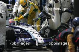 21.10.2007 Sao Paulo, Brazil,  A Willaims mechanic is knocked to to floor by Kazuki Nakajima (JPN) Williams F1 Team during a pit stop - Formula 1 World Championship, Rd 17, Brazilian Grand Prix, Sunday Race