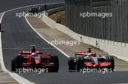 20.10.2007 Sao Paulo, Brazil,  Kimi Raikkonen (FIN), Räikkönen, Scuderia Ferrari passes Lewis Hamilton (GBR), McLaren Mercedes as he rolls towards the pits - Formula 1 World Championship, Rd 17, Brazilian Grand Prix, Saturday Qualifying