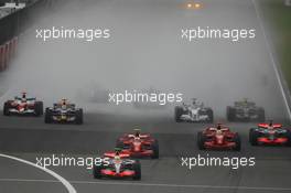 07.10.2007 Shanghai, China,  Start, Lewis Hamilton (GBR), McLaren Mercedes, MP4-22 leads Kimi Raikkonen (FIN), Räikkönen, Scuderia Ferrari, F2007 and Felipe Massa (BRA), Scuderia Ferrari, F2007 - Formula 1 World Championship, Rd 16, Chinese Grand Prix, Sunday Race