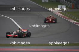 07.10.2007 Shanghai, China,  Lewis Hamilton (GBR), McLaren Mercedes, MP4-22 leads Kimi Raikkonen (FIN), Räikkönen, Scuderia Ferrari, F2007 - Formula 1 World Championship, Rd 16, Chinese Grand Prix, Sunday Race