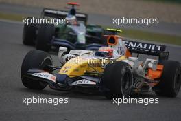 07.10.2007 Shanghai, China,  Heikki Kovalainen (FIN), Renault F1 Team, R27 leads Jenson Button (GBR), Honda Racing F1 Team, RA107 - Formula 1 World Championship, Rd 16, Chinese Grand Prix, Sunday Race