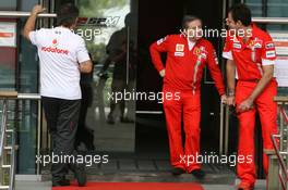 07.10.2007 Shanghai, China,  A team member from McLaren Mercedes Walks into the Ferrari building as Jean Todt (FRA), Scuderia Ferrari, Ferrari CEO talks outside - Formula 1 World Championship, Rd 16, Chinese Grand Prix, Sunday