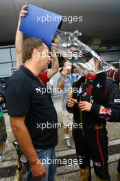 07.10.2007 Shanghai, China,  Vitantonio Liuzzi (ITA), Scuderia Toro Rosso is covered in water while talking to Gerhard Berger (AUT), Scuderia Toro Rosso, 50% Team Co Owner after he finished 6th in the race - Formula 1 World Championship, Rd 16, Chinese Grand Prix, Sunday