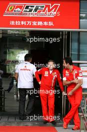 07.10.2007 Shanghai, China,  A team member from McLaren Mercedes Walks into the Ferrari building as Jean Todt (FRA), Scuderia Ferrari, Ferrari CEO talks outside - Formula 1 World Championship, Rd 16, Chinese Grand Prix, Sunday