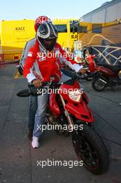 12.05.2007 Barcelona, Spain,  Michael Schumacher (GER), Scuderia Ferrari, Advisor leaves the track on a Ducati - Formula 1 World Championship, Rd 4, Spanish Grand Prix, Saturday