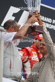 22.07.2007 Nürburg, Germany,  Ron Dennis (GBR), McLaren, Team Principal, Chairman gets his trophy from Michael Schumacher (GER), Scuderia Ferrari, Advisor - Formula 1 World Championship, Rd 10, European Grand Prix, Sunday Podium