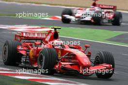 01.07.2007 Magny-Cours, France,  Kimi Raikkonen (FIN), Räikkönen, Scuderia Ferrari, F2007, Takuma Sato (JPN), Super Aguri F1, SA07 - Formula 1 World Championship, Rd 8, French Grand Prix, Sunday Race