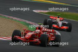 01.07.2007 Magny-Cours, France,  Kimi Raikkonen (FIN), Räikkönen, Scuderia Ferrari, F2007 and Lewis Hamilton (GBR), McLaren Mercedes, MP4-22 - Formula 1 World Championship, Rd 8, French Grand Prix, Sunday Race