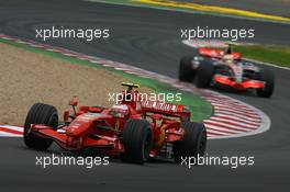 01.07.2007 Magny-Cours, France,  Kimi Raikkonen (FIN), Räikkönen, Scuderia Ferrari, F2007 and Lewis Hamilton (GBR), McLaren Mercedes, MP4-22 - Formula 1 World Championship, Rd 8, French Grand Prix, Sunday Race