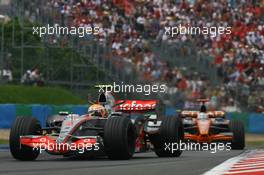 01.07.2007 Magny-Cours, France,  Lewis Hamilton (GBR), McLaren Mercedes, MP4-22 and Adrian Sutil (GER), Spyker F1 Team, F8-VII - Formula 1 World Championship, Rd 8, French Grand Prix, Sunday Race