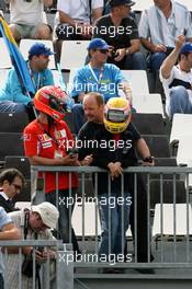 30.06.2007 Magny-Cours, France,  Fans of Michael Schumacher (GER), Scuderia Ferrari, Advisor and Lewis Hamilton (GBR), McLaren Mercedes watch the action - Formula 1 World Championship, Rd 8, French Grand Prix, Saturday Practice