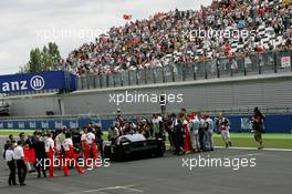 30.06.2007 Magny-Cours, France,  Photographers and personnel surround Michael Schumacher (GER), Scuderia Ferrari, Advisor and Zindedine Zidane (FRA), after they did a lap in the Ferrari FXX - Formula 1 World Championship, Rd 8, French Grand Prix, Saturday