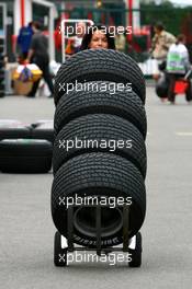28.06.2007 Magny-Cours, France,  Tanja Bauer (TV Moderator, Premiere), pushes tyres around the paddock - Formula 1 World Championship, Rd 8, French Grand Prix, Thursday