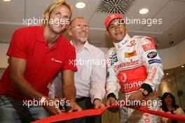 02.08.2007 Budapest, Hungary,  Lewis Hamilton (GBR), McLaren Mercedes with Tamas Kasas (HUN), Water Polo player cutting the ribbon to open the new Vodafone shop, Vodafone Karting and opening of shop in Budapest - Formula 1 World Championship, Rd 11, Hungarian Grand Prix, Thursday