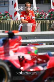 24.05.2007 Monte Carlo, Monaco,  Michael Schumacher (GER), Scuderia Ferrari, Advisor, watches the session from "La Rascasse" corner as Vitantonio Liuzzi (ITA), Scuderia Toro Rosso, STR02, drives past  - Formula 1 World Championship, Rd 5, Monaco Grand Prix, Thursday Practice