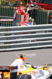 24.05.2007 Monte Carlo, Monaco,  Michael Schumacher (GER), Scuderia Ferrari, Advisor, watches the session from "La Rascasse" corner as Giancarlo Fisichella (ITA), Renault F1 Team, R27, drives past  - Formula 1 World Championship, Rd 5, Monaco Grand Prix, Thursday Practice