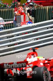 24.05.2007 Monte Carlo, Monaco,  Michael Schumacher (GER), Scuderia Ferrari, Advisor, watches the session from "La Rascasse" corner as Felipe Massa (BRA), Scuderia Ferrari, F2007, drives past  - Formula 1 World Championship, Rd 5, Monaco Grand Prix, Thursday Practice