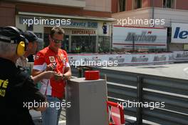 24.05.2007 Monte Carlo, Monaco,  Michael Schumacher (GER), Scuderia Ferrari, Advisor, watches the session from "La Rascasse" corner - Formula 1 World Championship, Rd 5, Monaco Grand Prix, Thursday