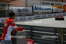 24.05.2007 Monte Carlo, Monaco,  Michael Schumacher (GER), Scuderia Ferrari, Advisor, watches the session from "La Rascasse" corner, passing: Felipe Massa (BRA), Scuderia Ferrari - Formula 1 World Championship, Rd 5, Monaco Grand Prix, Thursday