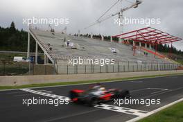 10.07.2007 Spa Francorchamps, Belgium,  New main grandstand in construction / Lewis Hamilton (GBR), McLaren Mercedes is passing - Formula 1 Testing