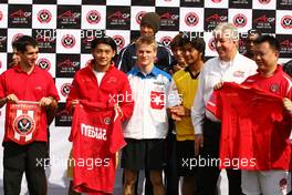 06.11.2008 Chengdu, China,  Ho Pin Tung (CHN), driver of A1 Team China hands over his team shirt for a football shirt - A1GP World Cup of Motorsport 2008/09, Round 2, Chengdu, Thursday - Copyright A1GP - Free for editorial usage