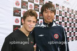 06.11.2008 Chengdu, China,  Marco Andretti (USA), driver of A1 Team USA with Li Tie (CHN) ex Everton football player now current Chengdu Blades player at the Chengdu Blades training ground for a friendly football match - A1GP World Cup of Motorsport 2008/09, Round 2, Chengdu, Thursday - Copyright A1GP - Free for editorial usage