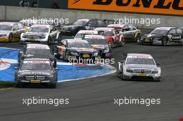 18.05.2008 Klettwitz, Germany,  Start of the race, with Paul di Resta (GBR), Team HWA AMG Mercedes, AMG Mercedes C-Klasse, leading the field into the first corner and Martin Tomczyk (GER), Audi Sport Team Abt Sportsline, Audi A4 DTM, flying over the kurbe stones - DTM 2008 at Lausitzring