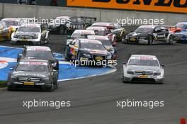 18.05.2008 Klettwitz, Germany,  Start of the race, with Paul di Resta (GBR), Team HWA AMG Mercedes, AMG Mercedes C-Klasse, leading the field into the first corner and Martin Tomczyk (GER), Audi Sport Team Abt Sportsline, Audi A4 DTM, flying over the kurbe stones - DTM 2008 at Lausitzring