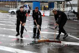 12.07.2008 Zandvoort, The Netherlands,  Mercedes Benz mechanics cleaning the mud and water out of the garage and the pitlane due to heavy rainshowers over the circuit. - DTM 2008 at Circuit Park Zandvoort