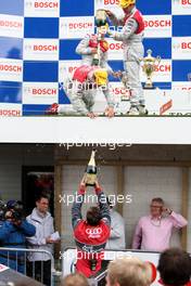 13.07.2008 Zandvoort, The Netherlands,  Champagne shower at the podium: Tom Kristensen (DNK), Audi Sport Team Abt, Audi A4 DTM pouring the champagne over Timo Scheider (GER), Audi Sport Team Abt, Audi A4 DTM. Teammember is awaiting the bottle. Even Norbert Haug standing underneath got wet! - DTM 2008 at Circuit Park Zandvoort