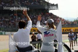 27.07.2008 Nürburg, Germany,  (left) Bruno Spengler (CDN), Team HWA AMG Mercedes, AMG Mercedes C-Klasse and (right) Susie Stoddart (GBR), Persson Motorsport AMG Mercedes, AMG Mercedes C-Klasse waving at the crowd. Watch the Mercedes Benz grandstand in the back. - DTM 2008 at Nürburgring